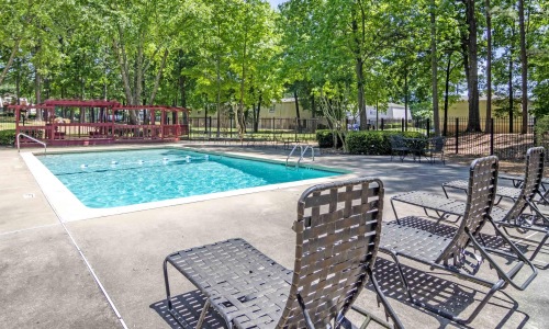 a pool with chairs around it